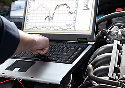 Car mechanic working in auto repair service.